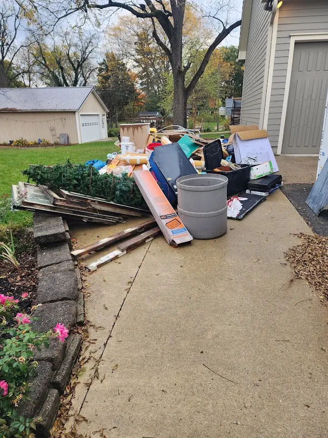 Dumpster being loaded with debris for Estate Cleanout Dumpster Rental in Yorktown